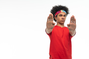 Serious guy in red tshirt shielding himslef