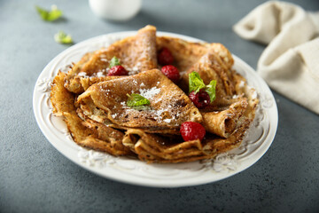 Traditional homemade crepes with raspberry