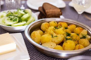 toasted young potatoes with dill in metal skillet