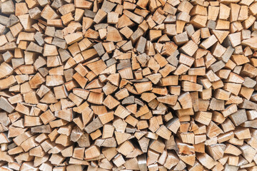 Firewood stack background of woodpile pattern cut from tree wood log with natural texture for fireplace fagot in winter