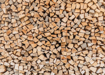 Firewood stack background of woodpile pattern cut from tree wood log with natural texture for fireplace in winter