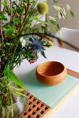 Scandinavian home design with wood bowl and flowers 
