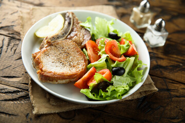 Baked pork chop with vegetable salad