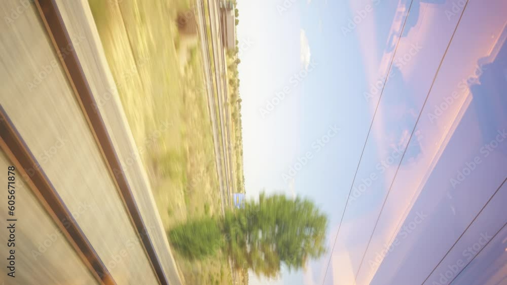Poster train tracks from a passenger window seen speeding by vertically
