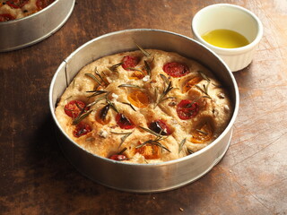 round Focaccia bread with rosemary and tomato