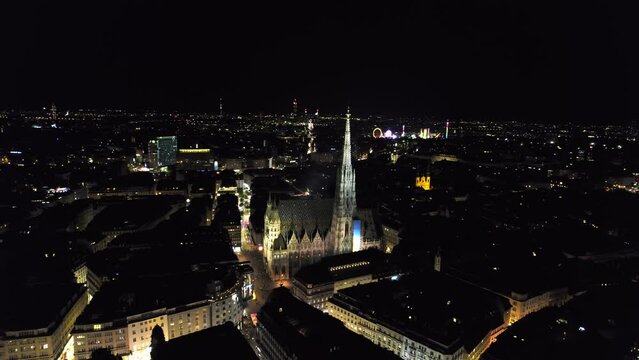 Aerial panoramic drone view of Vienna old town at night, with the Catholic St. Stephen's Cathedral (Stephansdom), the national symbol of Austria, UNESCO World Heritage Site, Vienna