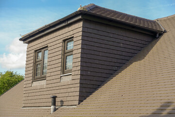 Grey tile covered side dormer of modern new build property