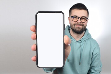 young man in glasses smartphone with white blank screen