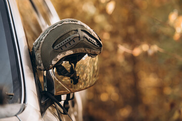 protective military helmet nato, on the background of the forest.