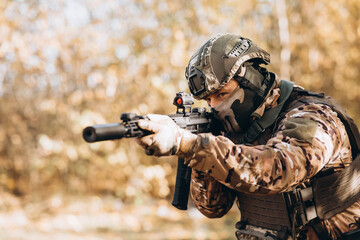 A man in a tactical police uniform with a weapon.