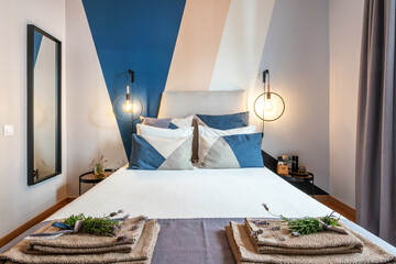 Bedroom with bed linen and lavender flowers for decoration and aromatherapy.