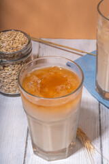 Iced barley orzo latte coffee, iced organic alternative coffee drink with crushed ice and non-dairy milk