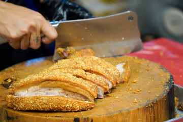 deep fried pork belly on a chopping board,Oriental roasted pork on a wooden chopping board,Oil-free frying concept