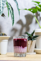 Mulberry smoothie on fresh milk in glass placed on wooden table