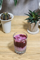 Mulberry smoothie on fresh milk in glass placed on wooden table