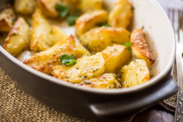 potatoes baked with sesame seeds, herbs and spices in the oven