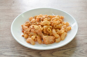 stir fried rigatoni pasta with chicken dressing ketchup on plate