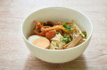steamed large rice noodles topping slice fried Chinese sausage and pork belly with bean sprout dressing black soy sauce on bowl