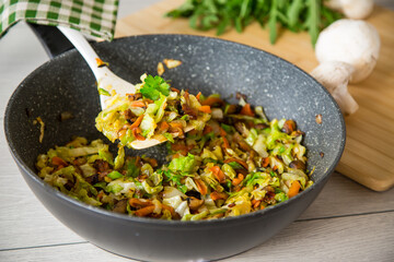 cabbage early fried with mushrooms, carrots and vegetables