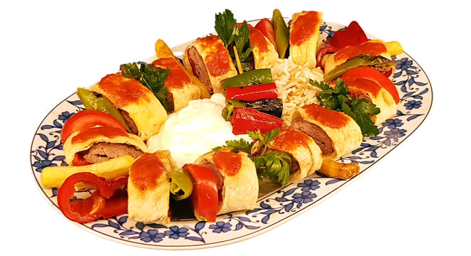 isolated turkish flavor bakery beyti kebab on a plate served with onion, tomato, pepper and bulgur pilaf