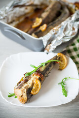 Baked fish with seasonings and spices in a plate