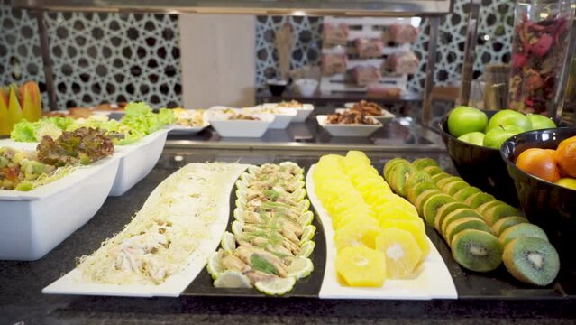 Dessert buffet with tropical fruits and a variety of food and snacks for restaurant customers in the hotel.