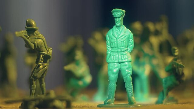 Murder of army general imitation, man knocks over plastic toy soldier with snap, end of war. Violence war resistance and peace without armored invasion