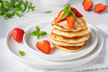 Yummy and fresh mini pancakes with strawberry for summer breakfast