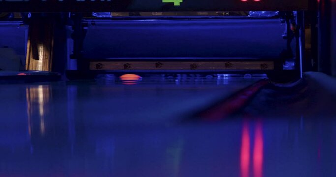 The bowling ball successfully knocks down the last three pins, completing the player's spare.The next round of bowling begins.




