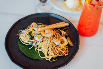 Spicy Seafood Spaghetti is a popular Thai dish that is a fusion of Italian pasta and Thai cuisine. 