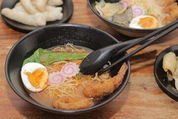 Homemade Japanese Pork Seafood Ramen with tomyam soup, pakcoy, eggs, shrimp flour, squid flour and Eggs