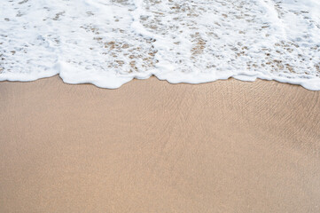 Sand beach and waves foam