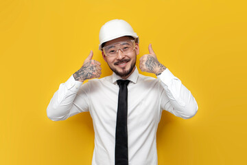 asian foreman in shirt with tie showing likes over yellow isolated background, korean civil engineer in formal wear