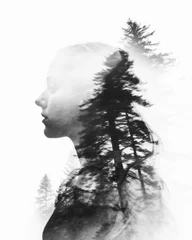 An artistic portrait of a woman blended with a forest in a black and white double exposure style © miketea88