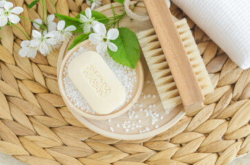Wooden massage foot brush with natural bristles, bath salt and bar of soap. Eco friendly toiletries. Natural beauty treatment, zero waste concept.