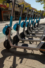 Row of electric scooters on street