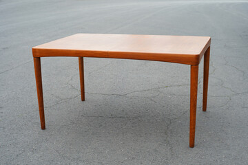 A mid century teak dining table from the 50s 60s Danish Design Vintage Dining solid wood Modern antique retro original isolated on white wall in modern living room closeup side front view