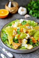 Salad with baked pumpkin, orange, feta cheese, lettuce, olive oil and grain mustard