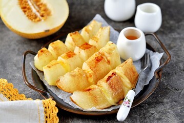 Baked melon with soft cheese and cinnamon