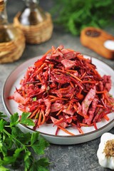 Salad with boiled meat, beets, carrots, onions, garlic, bell peppers with olive oil and wine vinegar