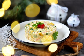 Festive Russian salad with shrimps, canned corn, cucumber, egg, cheese and mayonnaise