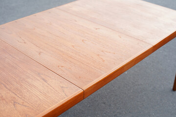 A mid century teak dining table from the 50s 60s Danish Design Vintage Dining solid wood Modern antique retro original isolated on white wall in modern living room closeup side front view