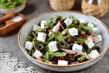 Salad with arugula, feta cheese, beetroot and chicken. Healthy food