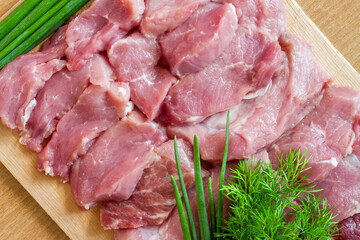 Fresh raw meat on a cutting board.