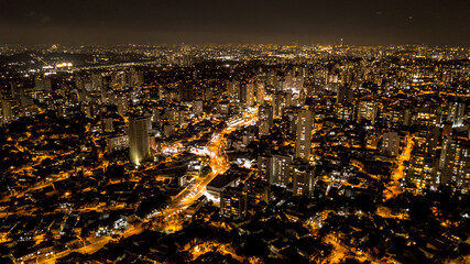 view from above the city of São Paulo at night, city lights, buildings and houses lit, Brazil