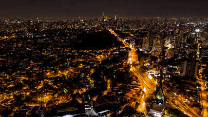 Naklejka premium view from above the city of São Paulo at night, city lights, buildings and houses lit, Brazil