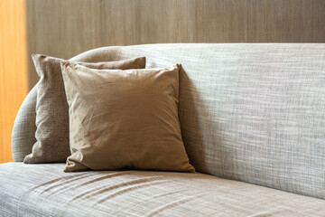 A pillow set on armchair or sofa in contemporary style. Interior decoration and furniture object photo.	
