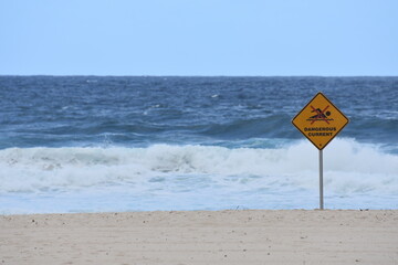 Dangerous current sign, warning swimmers and surfers of the rough water where they are recreating off the beach in Bondi beach, Sydney, Australia