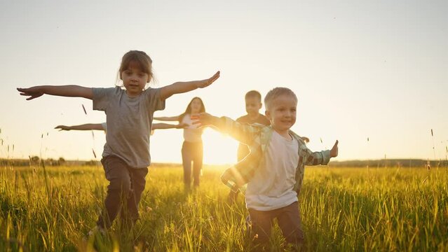 happy family. people in park kid a children together run in park at sunset silhouette. brother sister daughter son run. happy family and little baby child summer. kid dream concept. children run fun