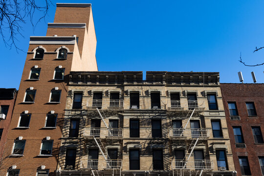 Row of Old Apartment Buildings with Fire Escapes on the Upper East Side of New York City
